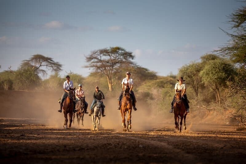Guests on a horseback safari across the plains of Laikipia