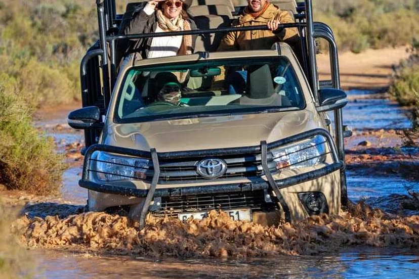 Open 4x4 crossing a river on safari