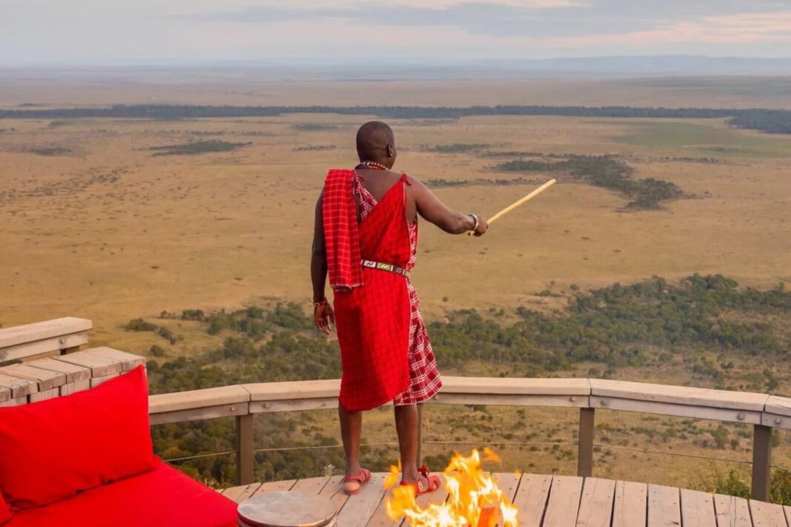 Fire-pit sundowner at a Masai Mara camp